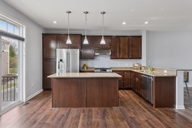 8949 Village Loop, Chanhassen, MN 55317 - kitchen with appliances with stainless steel finishes, under cabinet range hood, dark brown cabinets, dark wood-style floors, and recessed lighting