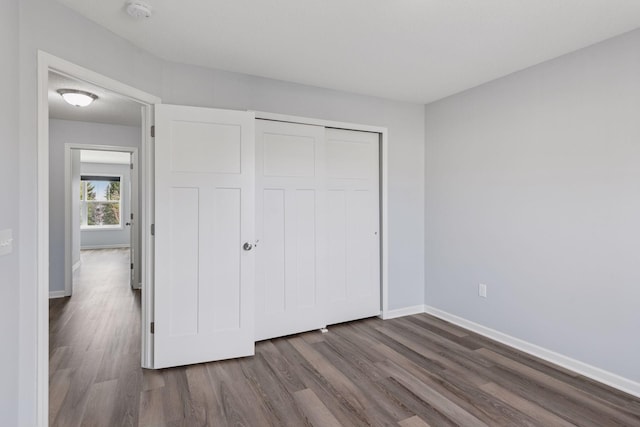 8949 Village Loop, Chanhassen, MN 55317 - unfurnished bedroom featuring dark wood-style flooring and a closet