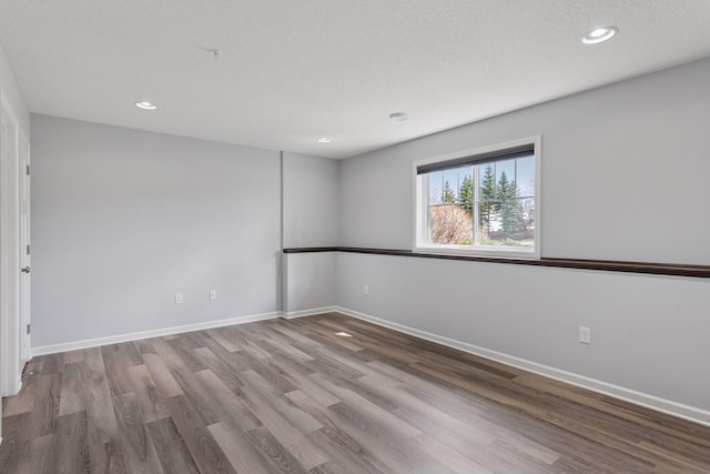 8949 Village Loop, Chanhassen, MN 55317 - spare room featuring wood finished floors and recessed lighting