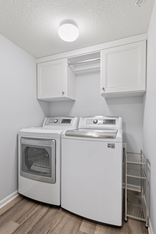 8949 Village Loop, Chanhassen, MN 55317 - washroom with separate washer and dryer, cabinet space, wood finished floors, and a textured ceiling