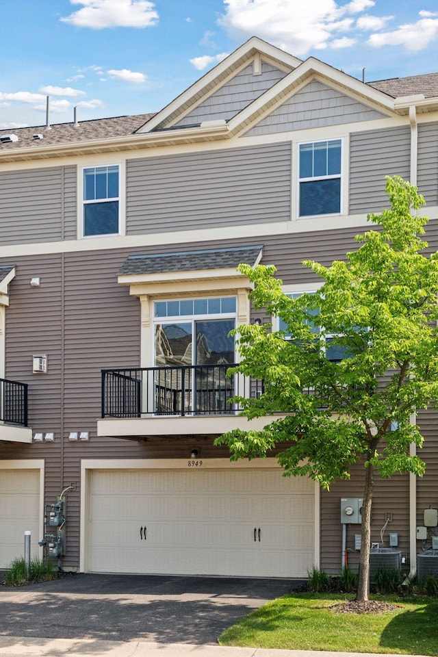 8949 Village Loop, Chanhassen, MN 55317 - back of house with asphalt driveway and an attached garage