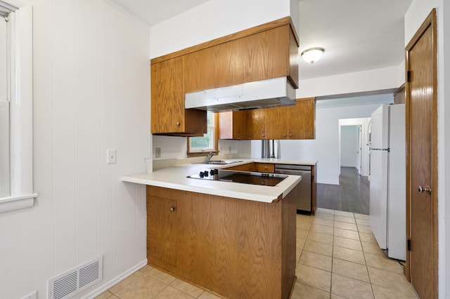 4337 Colorado Ave N, Crystal, MN 55422 - kitchen with freestanding refrigerator, stainless steel dishwasher, a peninsula, light countertops, and brown cabinetry
