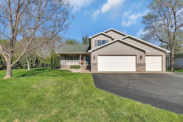 906 Cory Ln, Saint Cloud, MN 56303 - view of front facade featuring driveway, a porch, brick siding, and an attached garage