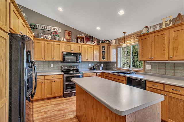 906 Cory Ln, Saint Cloud, MN 56303 - kitchen with black appliances, lofted ceiling, light wood-style flooring, decorative backsplash, and light countertops