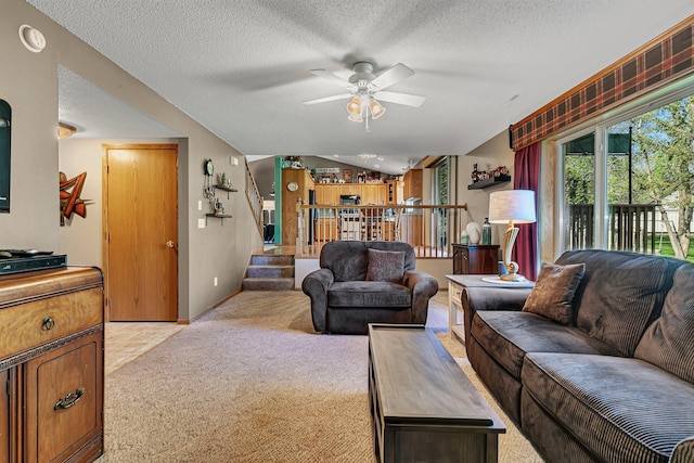 906 Cory Ln, Saint Cloud, MN 56303 - living room featuring light colored carpet, ceiling fan, a textured ceiling, vaulted ceiling, and stairway