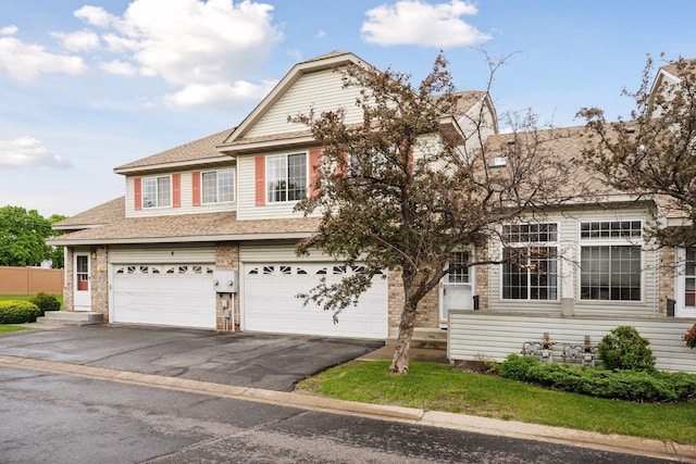 14220 Xenon St NW Unit 6Nw, Ramsey, MN 55303 - view of front of house with driveway, a shingled roof, and a garage