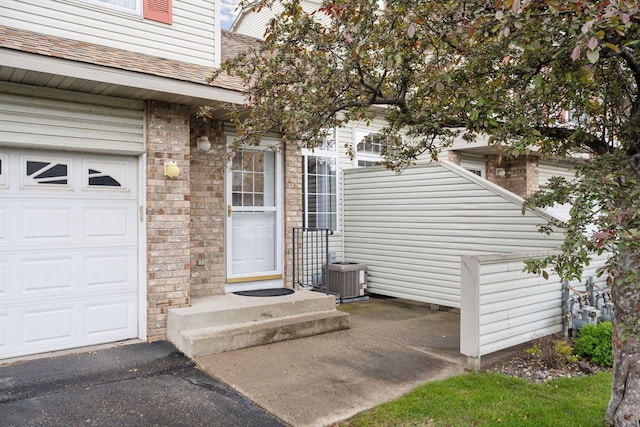 14220 Xenon St NW Unit 6Nw, Ramsey, MN 55303 - entrance to property with a garage and a shingled roof