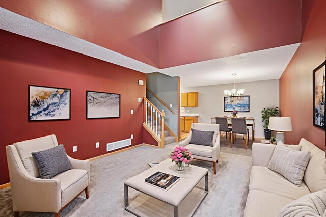 14220 Xenon St NW Unit 6Nw, Ramsey, MN 55303 - living room with a chandelier, stairway, and light carpet