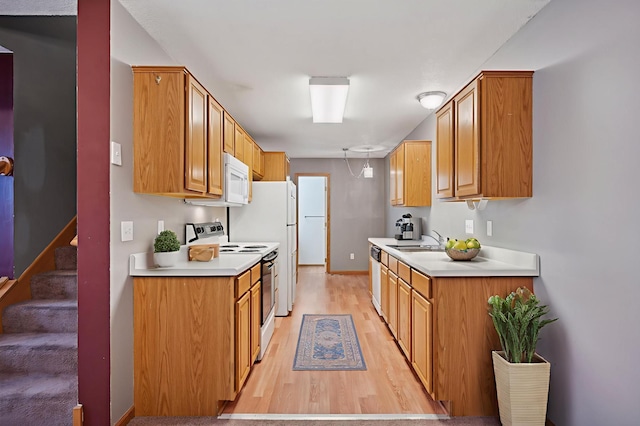 14220 Xenon St NW Unit 6Nw, Ramsey, MN 55303 - kitchen featuring white appliances, light wood-style flooring, light countertops, and brown cabinetry