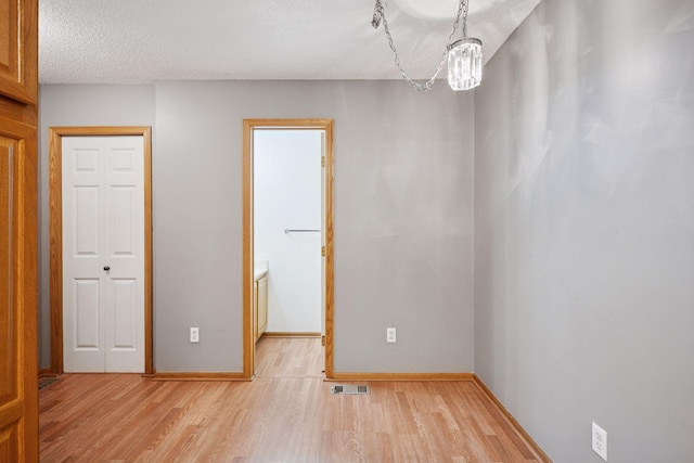 14220 Xenon St NW Unit 6Nw, Ramsey, MN 55303 - unfurnished room with light wood-type flooring and a textured ceiling