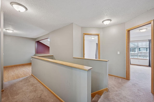 14220 Xenon St NW Unit 6Nw, Ramsey, MN 55303 - hallway featuring an upstairs landing, carpet, and a textured ceiling
