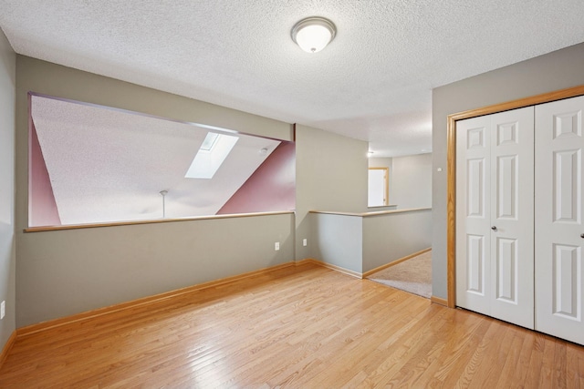 14220 Xenon St NW Unit 6Nw, Ramsey, MN 55303 - below grade area with wood finished floors and a textured ceiling