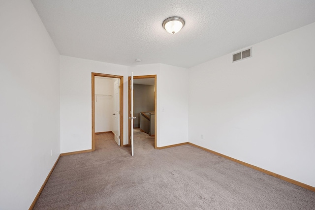 14220 Xenon St NW Unit 6Nw, Ramsey, MN 55303 - unfurnished bedroom with a spacious closet, light colored carpet, a textured ceiling, and a closet