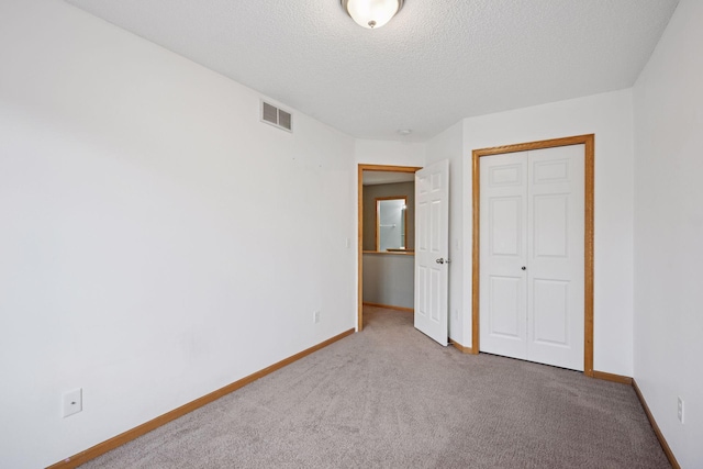 14220 Xenon St NW Unit 6Nw, Ramsey, MN 55303 - unfurnished bedroom with carpet floors, a closet, and a textured ceiling