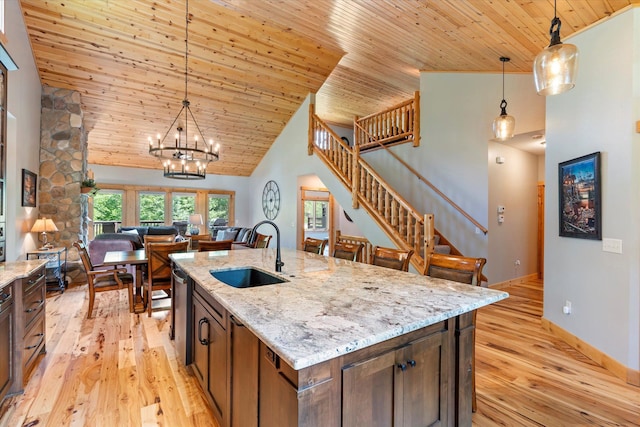 34792 Shore Ln, Crosslake, MN 56442 - kitchen with wood ceiling, high vaulted ceiling, light wood-style flooring, decorative light fixtures, and light stone countertops