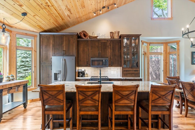34792 Shore Ln, Crosslake, MN 56442 - kitchen with appliances with stainless steel finishes, wood ceiling, light wood-type flooring, tasteful backsplash, and dark brown cabinets