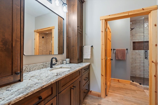 34792 Shore Ln, Crosslake, MN 56442 - bathroom featuring vanity, a stall shower, and wood finished floors