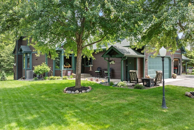 34792 Shore Ln, Crosslake, MN 56442 - view of front of property with concrete driveway, a front yard, a shingled roof, and a garage