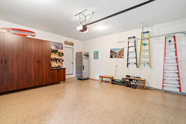 34792 Shore Ln, Crosslake, MN 56442 - garage featuring a garage door opener and stainless steel refrigerator
