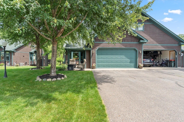 34792 Shore Ln, Crosslake, MN 56442 - view of front of house featuring asphalt driveway, a garage, and a front yard