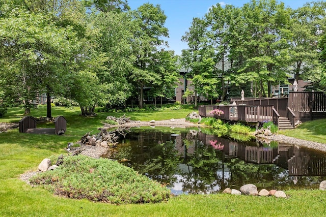 34792 Shore Ln, Crosslake, MN 56442 - view of grassy yard featuring a wooden deck and a small pond