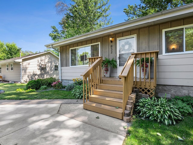 832 10th Ave SE, Forest Lake, MN 55025 - property entrance with board and batten siding, a patio, and a yard