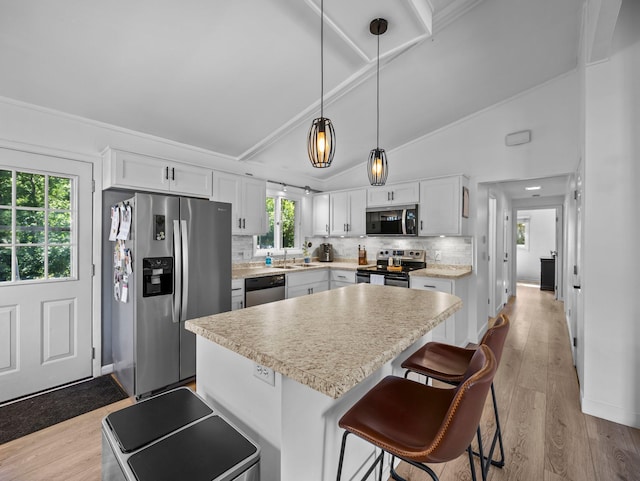 832 10th Ave SE, Forest Lake, MN 55025 - kitchen featuring stainless steel appliances, backsplash, white cabinetry, a kitchen island, and light countertops