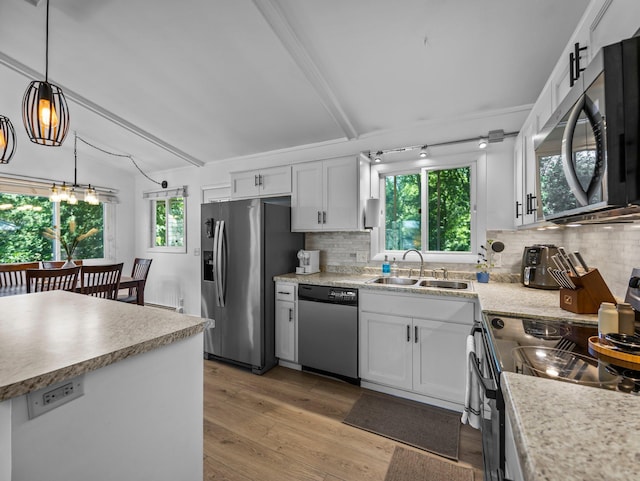 832 10th Ave SE, Forest Lake, MN 55025 - kitchen with stainless steel appliances, light wood-style flooring, plenty of natural light, backsplash, and beamed ceiling