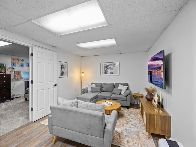 832 10th Ave SE, Forest Lake, MN 55025 - living room with light wood finished floors, a drop ceiling, and a baseboard heating unit