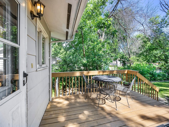 832 10th Ave SE, Forest Lake, MN 55025 - deck featuring outdoor dining area and view of scattered trees