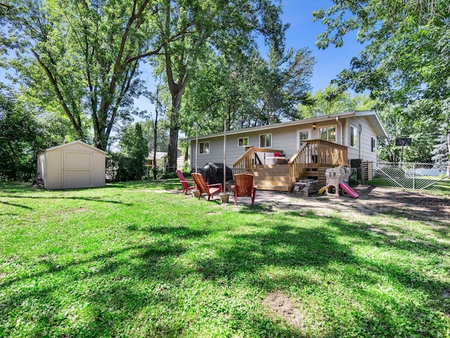 832 10th Ave SE, Forest Lake, MN 55025 - fenced backyard with a wooden deck and a storage unit