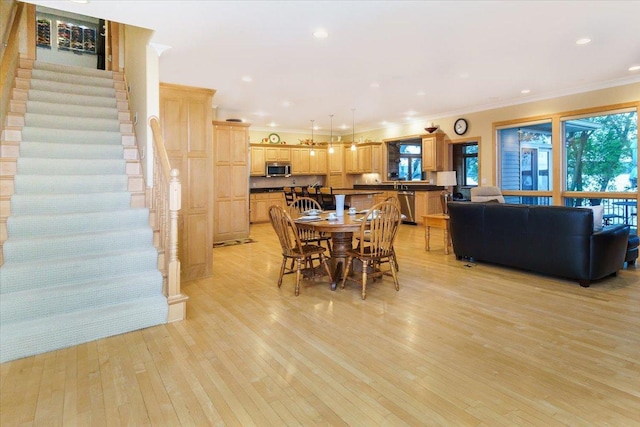 2719 Spring Lake Rd SW, Prior Lake, MN 55372 - dining space with stairs, plenty of natural light, crown molding, light wood-style flooring, and recessed lighting