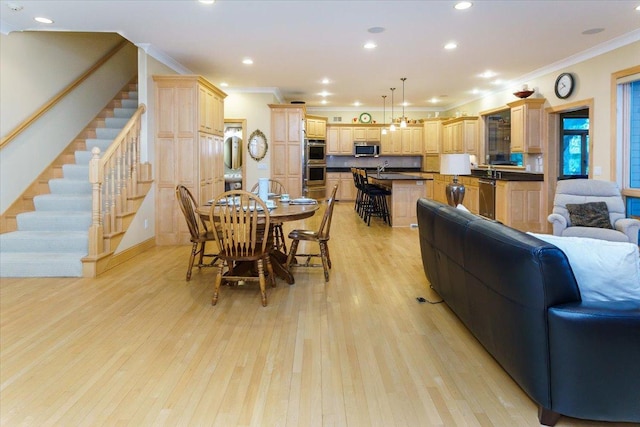 2719 Spring Lake Rd SW, Prior Lake, MN 55372 - dining space with crown molding, light wood finished floors, stairway, and recessed lighting