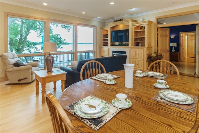 2719 Spring Lake Rd SW, Prior Lake, MN 55372 - dining space with a fireplace, light wood finished floors, ornamental molding, and recessed lighting