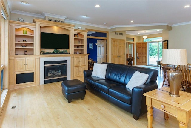 2719 Spring Lake Rd SW, Prior Lake, MN 55372 - living room with light wood finished floors, a glass covered fireplace, recessed lighting, and crown molding