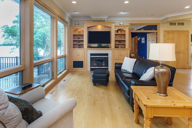 2719 Spring Lake Rd SW, Prior Lake, MN 55372 - living area with light wood-style floors, recessed lighting, a glass covered fireplace, and ornamental molding