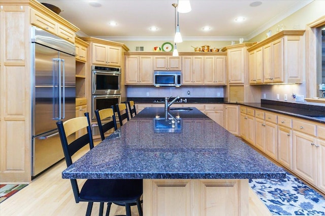 2719 Spring Lake Rd SW, Prior Lake, MN 55372 - kitchen featuring appliances with stainless steel finishes, light brown cabinets, a breakfast bar area, ornamental molding, and dark countertops