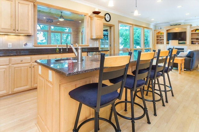 2719 Spring Lake Rd SW, Prior Lake, MN 55372 - kitchen featuring light brown cabinetry, crown molding, open floor plan, plenty of natural light, and light wood-style flooring