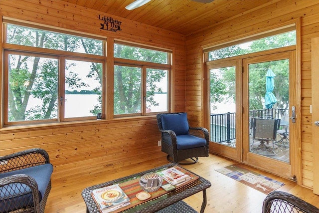 2719 Spring Lake Rd SW, Prior Lake, MN 55372 - sunroom featuring wood finished floors, wood walls, and a water view