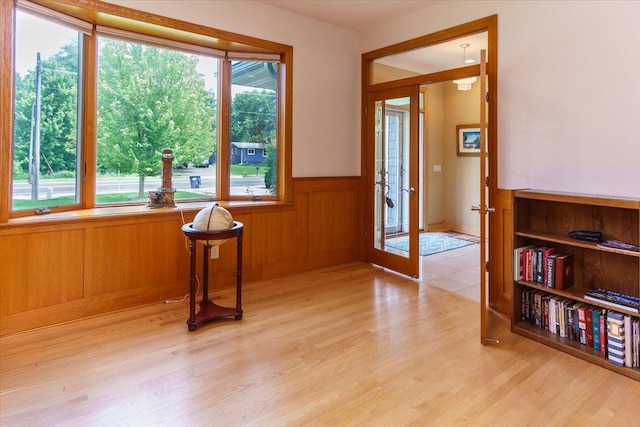 2719 Spring Lake Rd SW, Prior Lake, MN 55372 - unfurnished room with french doors, a wainscoted wall, and light wood-style floors