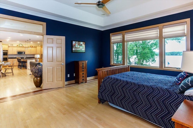 2719 Spring Lake Rd SW, Prior Lake, MN 55372 - bedroom with light wood finished floors, a tray ceiling, and a ceiling fan