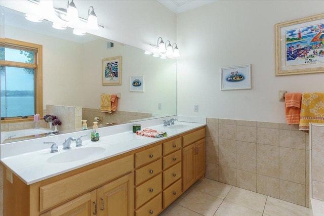 2719 Spring Lake Rd SW, Prior Lake, MN 55372 - bathroom featuring double vanity, tile patterned floors, tile walls, a wainscoted wall, and a chandelier