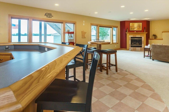2719 Spring Lake Rd SW, Prior Lake, MN 55372 - bar area featuring light carpet, recessed lighting, and a tile fireplace
