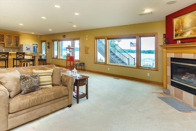 2719 Spring Lake Rd SW, Prior Lake, MN 55372 - living area featuring light colored carpet, recessed lighting, a tiled fireplace, and bar