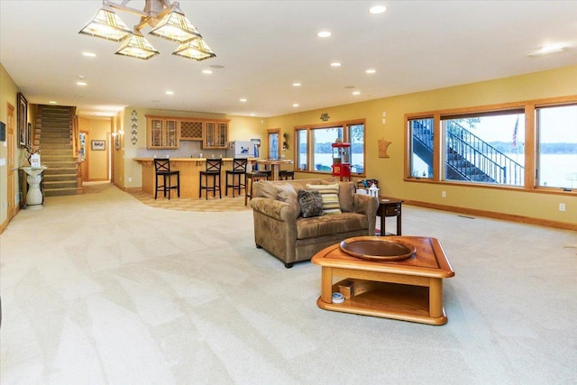 2719 Spring Lake Rd SW, Prior Lake, MN 55372 - living area featuring light colored carpet, recessed lighting, stairway, and bar area