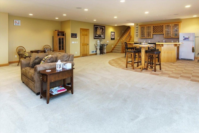 2719 Spring Lake Rd SW, Prior Lake, MN 55372 - living area with bar area, light colored carpet, stairway, and recessed lighting