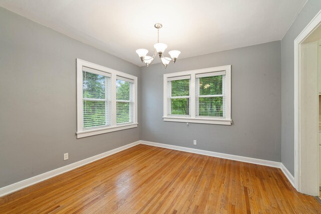 1921 Minneapolis Ave, Duluth, MN 55803 - unfurnished room with a chandelier and light wood-style flooring