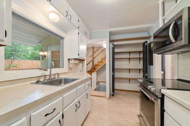 1921 Minneapolis Ave, Duluth, MN 55803 - kitchen featuring stainless steel appliances, light countertops, white cabinets, and light floors
