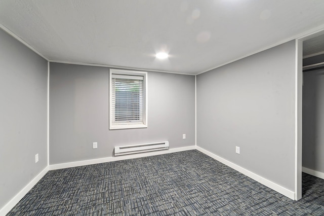 1921 Minneapolis Ave, Duluth, MN 55803 - unfurnished bedroom featuring a baseboard heating unit and dark colored carpet