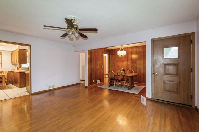 1501 100th St, Bloomington, MN 55431 - entryway featuring wood finished floors, a ceiling fan, and a chandelier